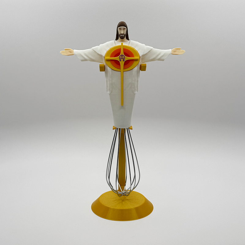 Eggbeater Jesus whisk ornament on the gold display stand