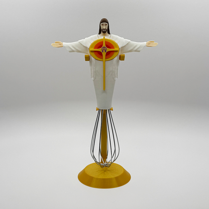 Eggbeater Jesus whisk ornament on the gold display stand