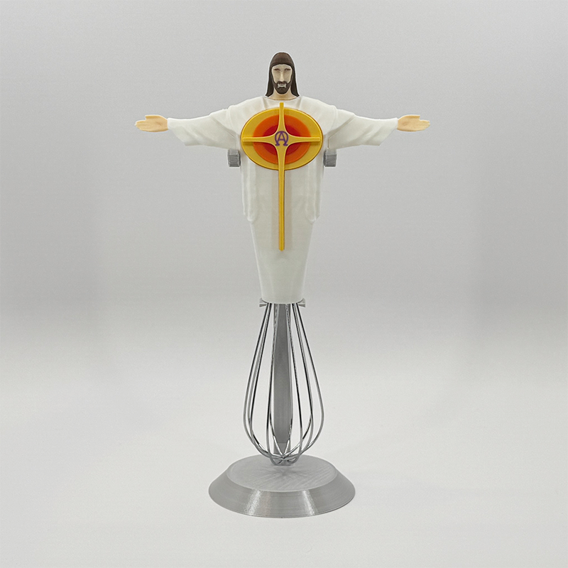 Eggbeater Jesus whisk ornament on the silver display stand