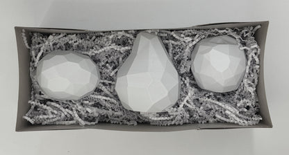 The planar apple, pear and lemon packed together in a gift box with crinkle paper